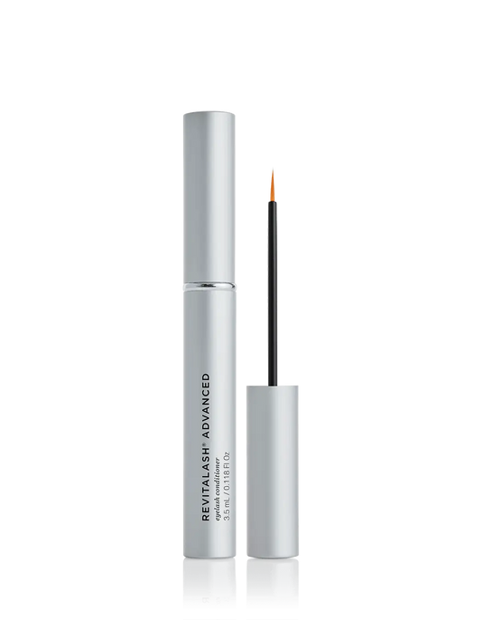 A bottle of RevitaLash Advanced eyelash conditioning serum with the brand name displayed prominently on the packaging. The product is shown with the cap off, revealing the applicator wand.
